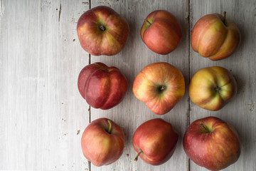 Summer red apples on white boards on the right