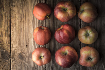 Summer red apples on the old board to the right