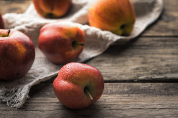 Red apples and towel on the old boards