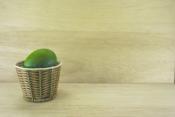 green egg in rattan basket