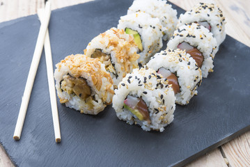Sushi rolls on a slate plate