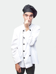 Worried chef with bad smell gesture