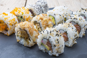 Sushi rolls on a slate plate