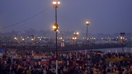 Pan shot of Hindu pilgrims at riverbank during Kumbh mela, Ganges River, Allahabad, Uttar Pradesh, India