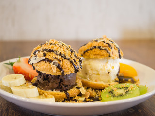 Chocolate choux ice cream set with kiwi and strawberry, backgrou