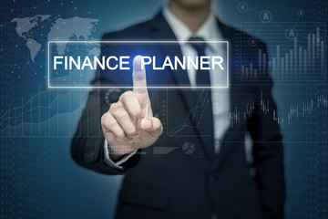 Businessman hand touching FINANCE PLANNER button on virtual scre