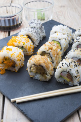 Sushi rolls on a slate plate