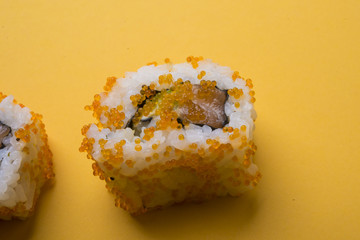 Various kinds of sushi food served on yellow blackground