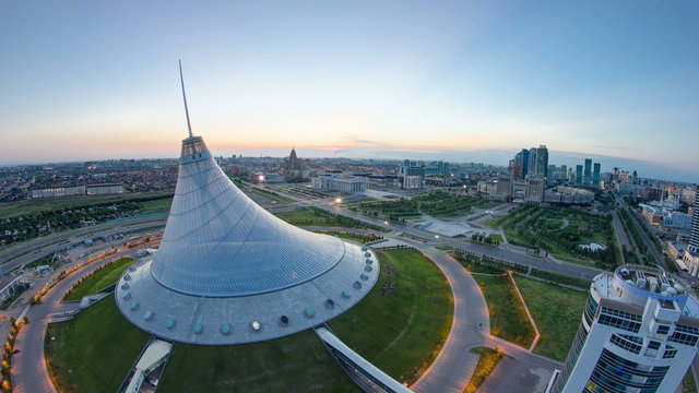 Elevated view over the city center with Khan Shatyr and central business district night to day Timelapse, Kazakhstan, Astana