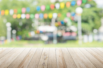 Empty wooden table with blurred party on background