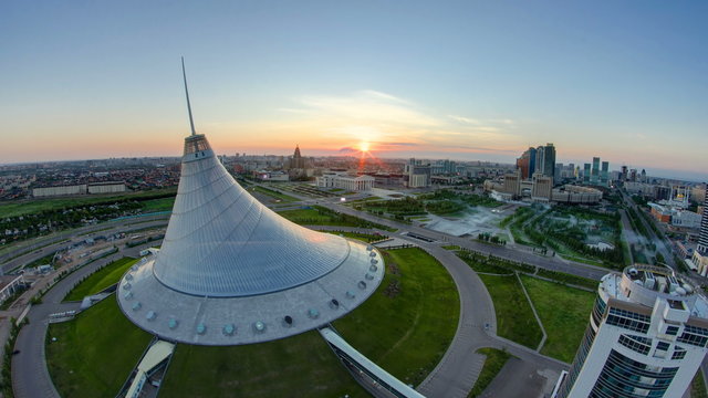 Elevated view with sunrise over the city center with Khan Shatyr and central business district Timelapse, Kazakhstan, Astana