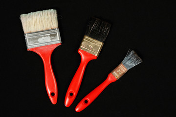 Three red paintbrush