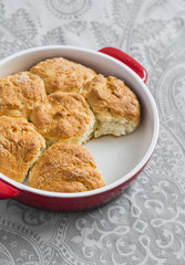 Simple scones in the baking dish on a gray background
