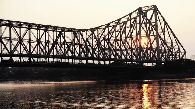 Shot of the Howrah Bridge over Hooghly River at dusk, Kolkata, West Bengal, India