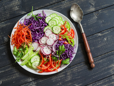 Raw Crunchy Colorful Coleslaw With Red Cabbage, Radish, Cucumber, Sweet Peppers, Carrots, Parsley And Sesame Seeds. Healthy Vegetarian Food