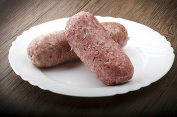 pork sausage (cotechino) with polenta on the wood table