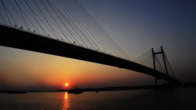 Time lapse shot of the Vidyasagar Setu over Hooghly River at dusk, Kolkata, West Bengal, India
