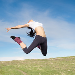 Attractive young woman jumping outdoors