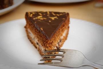 Piece of brownie - chocolate cake with cherry. Shallow focus.