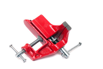 Close up view of a metal table vise clamp isolated on a white background.