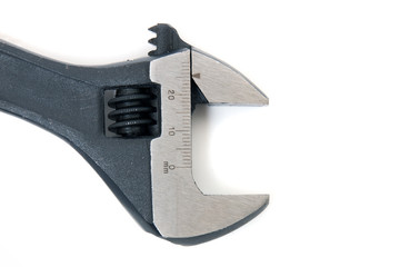 Close up view of an adjustable wrench isolated on a white background.