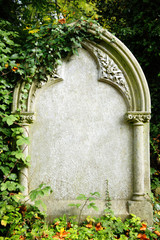 Blank tombstone grave of a recent funeral burial in an old cemetery with copy space for Halloween gravestone horror death backgrounds