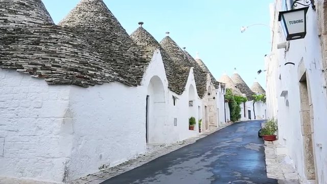 Pan shot of Trulli houses in a town, Alberobello, Puglia, Italy