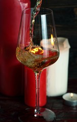 Pouring white wine into the wineglass