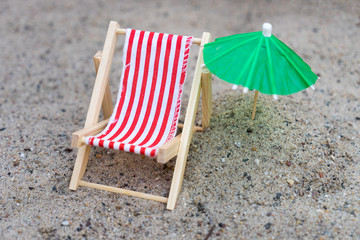 Fototapeta na wymiar Sun chair and umbrella / Sun chair and umbrella stand in the sand