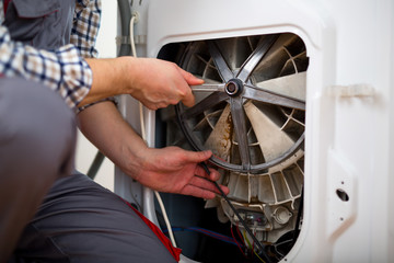 Technician repairing a washing machine