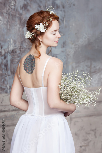 young red haired bride in elegant wedding dress she stands with her