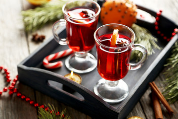 Obraz na płótnie Canvas Mulled wine in glass on grey wooden table