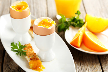 Boiled egg with toasts on a grey wooden table