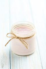 Strawberry yogurt in bowl on a blue wooden table