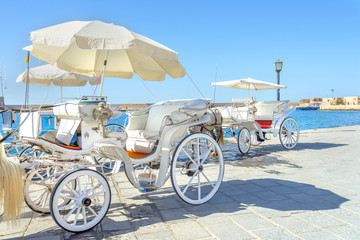 Fototapeta na wymiar Horse carriage in the port of Chania, Crete