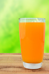 Fresh orange juice on wooden table.