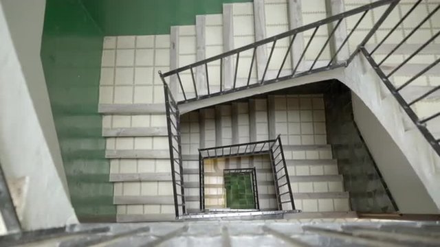 Old stairwell seen from a high angle with with a dolly move. UHD, 4K