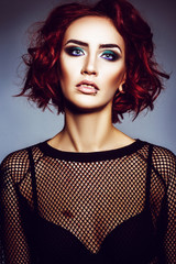 Beautiful gothic girl hipster model with piercings, with red hair, make-up art in black svitshote...