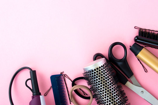 Hairdressing tools on a pink background