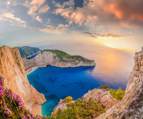 Navagio beach with shipwreck against sunset on Zakynthos island in Greece