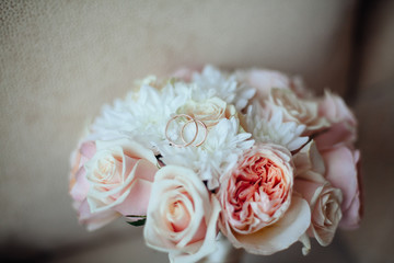 Beautiful white wedding bouquet with rings