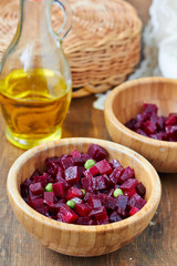 Homemade beetroot salad with green peas in a wooden bowl