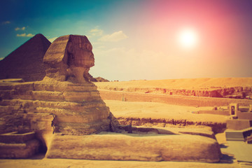 The full profile of the Great Sphinx with the pyramid in the background in Giza.