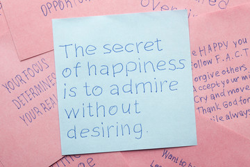 Sticky note with the secret of happiness