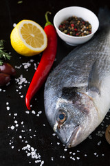 Fresh fish dorado with fragrant spices, herbs and spices