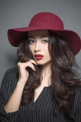 Fashion model woman with dark red hat on