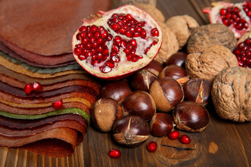 selection of various colorful spices, fruit, nuts on a wooden table