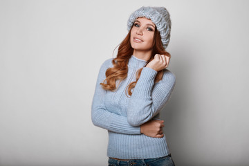 Portrait of beautiful redhead woman in sweater