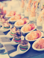 Spoons with seafood snacks, toned