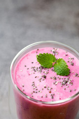 Smoothie, pink juice on the grey  background.